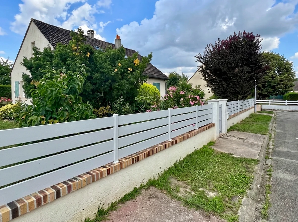 Pergola bioclimatique à lames orientables en aluminium anthracite, vue depuis la terrasse vers le jardin paysager
