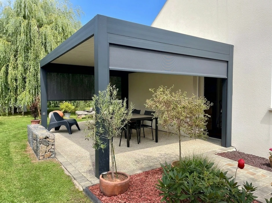 Pergola bioclimatique aluminium anthracite installée en terrasse attenante à une maison pavillonnaire