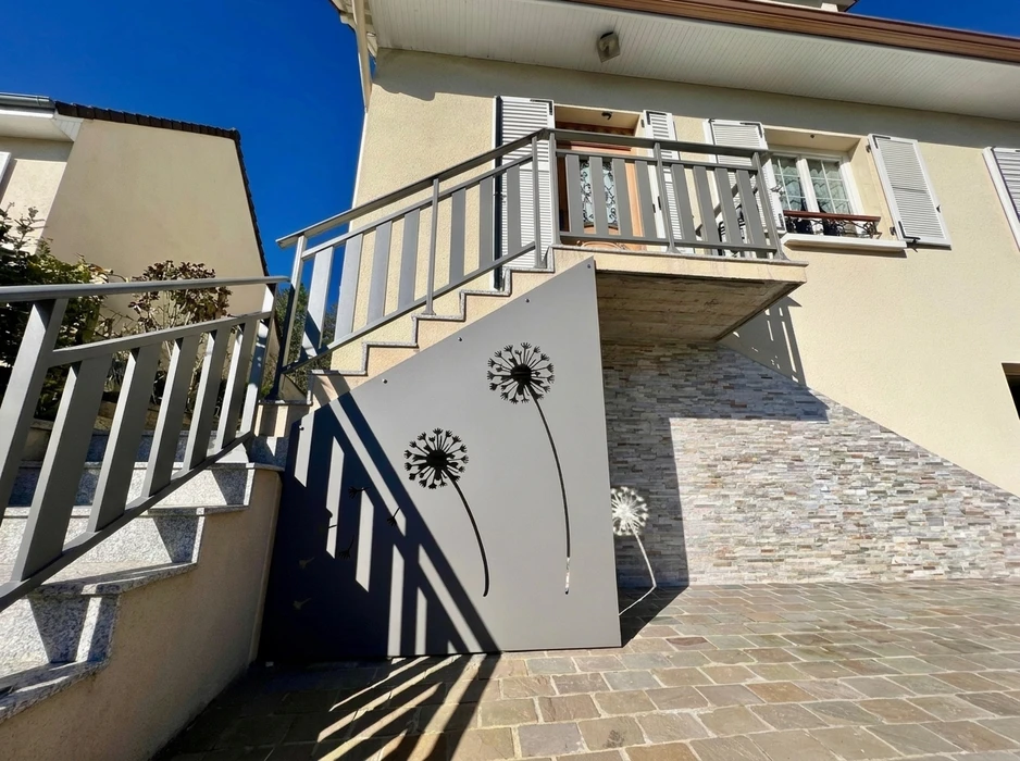 Terrasse couverte vue de l'intérieur, pergola bioclimatique à lames orientables en aluminium blanc, position ouverte laissant apparaître un ciel bleu nuageux